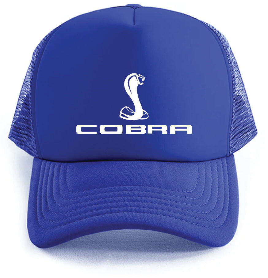 The Cobra Hat by Corsa Clothing is a blue cap featuring a white stylized cobra logo and "COBRA" on the front, with a mesh back and a solid curved brim.