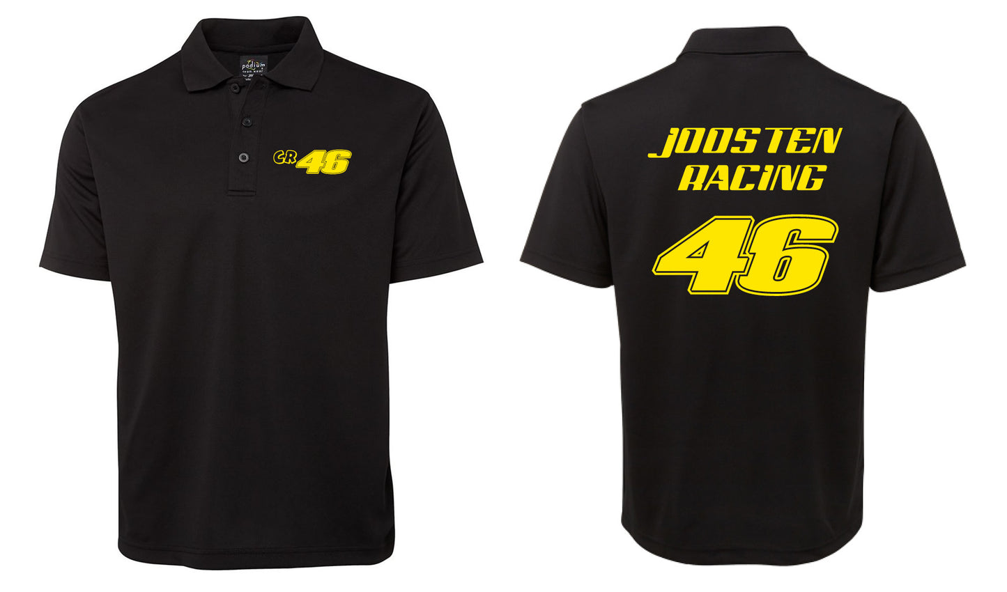 The Corsa Clothing CR 46 Shirt is a black polo featuring a small yellow 46 logo on the left chest and bold yellow JOOSTEN RACING lettering above a large yellow 46 on the back.