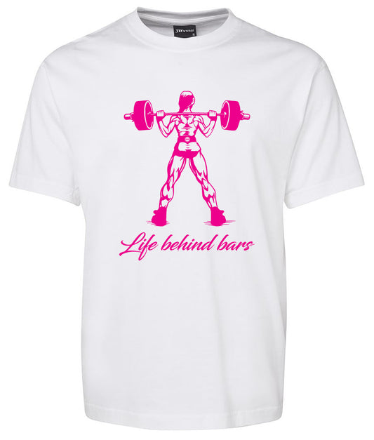 The Life Behind Bars Lifting Girl shirt by Corsa Clothing is a white tee with a pink graphic of a muscular girl lifting a barbell from behind and “Life behind bars” written in cursive below the image.
