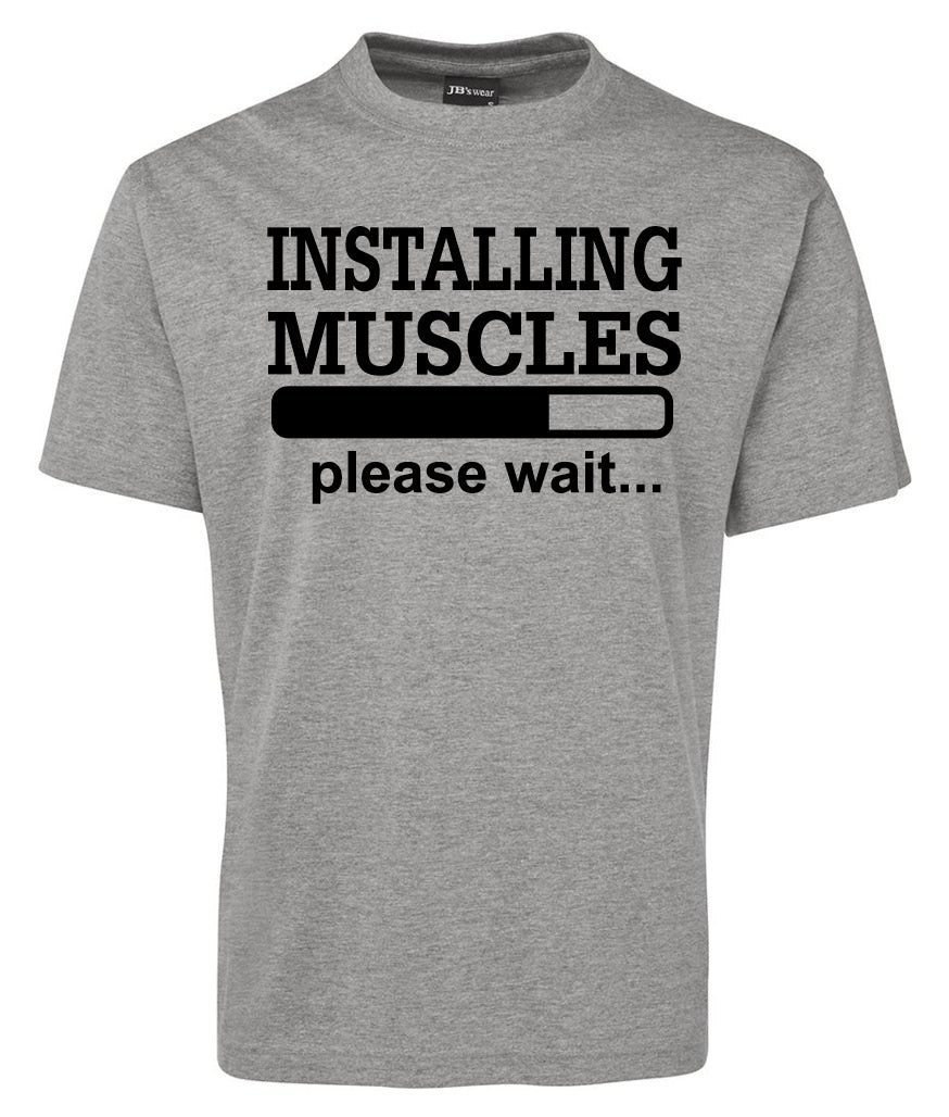 The Corsa Clothing INSTALLING MUSCLES Shirt is a gray tee featuring black text that says "INSTALLING MUSCLES" above a loading bar graphic, with "please wait..." below the bar.