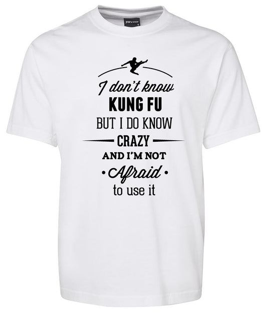 The Kung Fu Crazy Shirt by Corsa Clothing is a white tee featuring black text and a graphic of a person kicking. The shirt reads: I don't know kung fu but I do know crazy and I'm not afraid to use it.