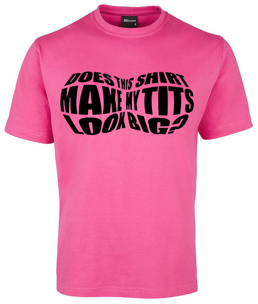The Make My Tits Look Big Shirt by Corsa Clothing is a pink tee featuring bold black text, “DOES THIS SHIRT MAKE MY TITS LOOK BIG?” in a distorted, curved font across the chest.