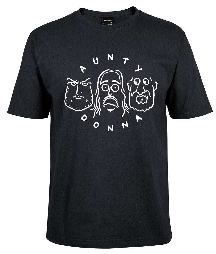 The Aunty Donna Shirt by Corsa Clothing is a black tee with white line drawings of three cartoon faces and "AUNTY DONNA" displayed in an arc above and below the faces.