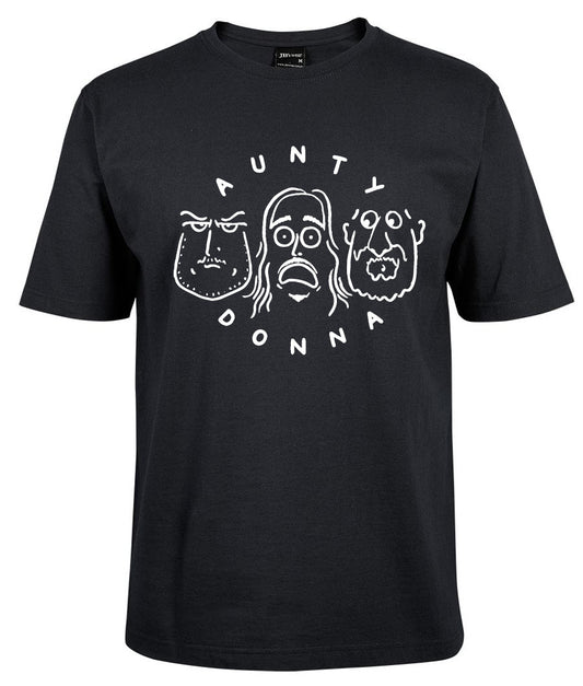 The Aunty Donna Shirt by Corsa Clothing is a black tee with white line drawings of three cartoon faces and "AUNTY DONNA" displayed in an arc above and below the faces.