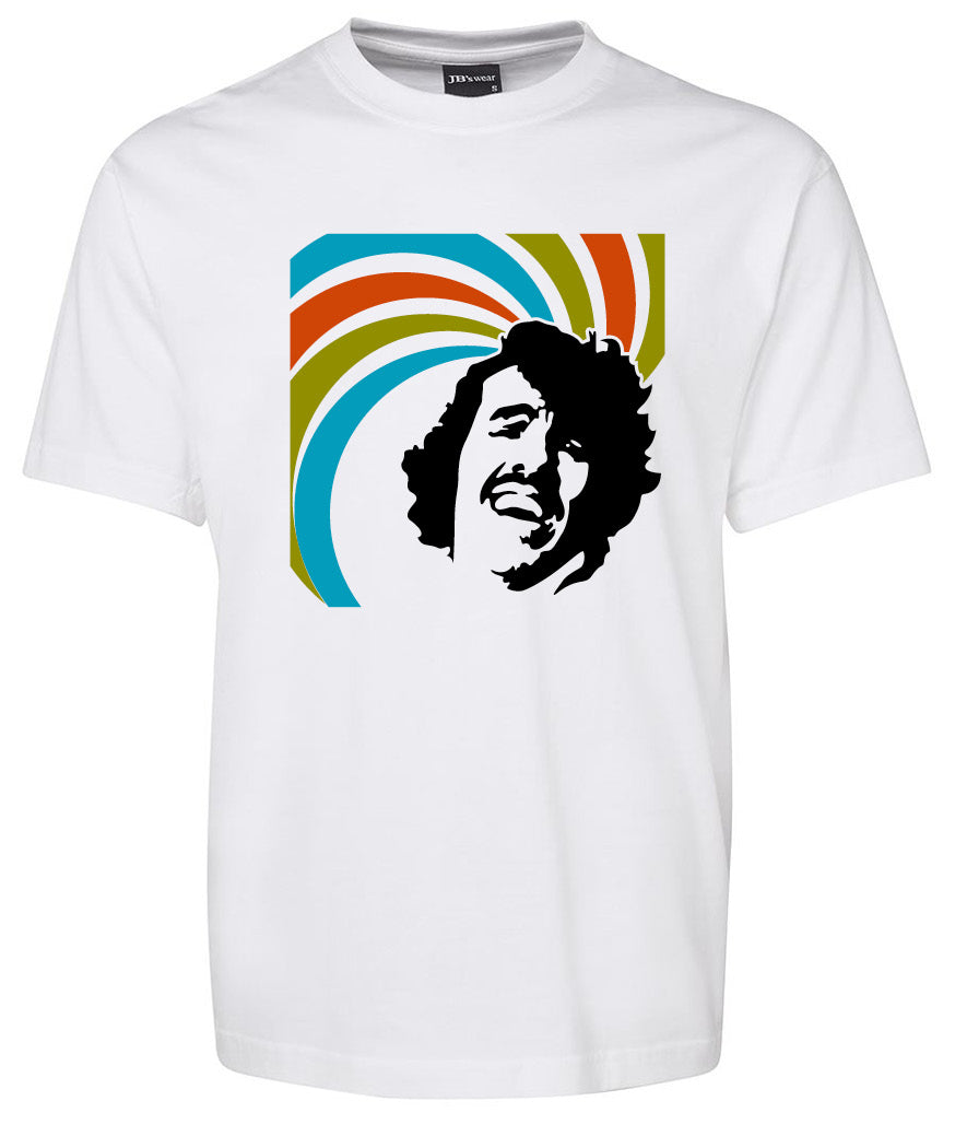 The Stephen Teakle Shirt by Corsa Clothing is a white tee with a black silhouette of a smiling man's face, set against curved blue, green, orange, and red lines.