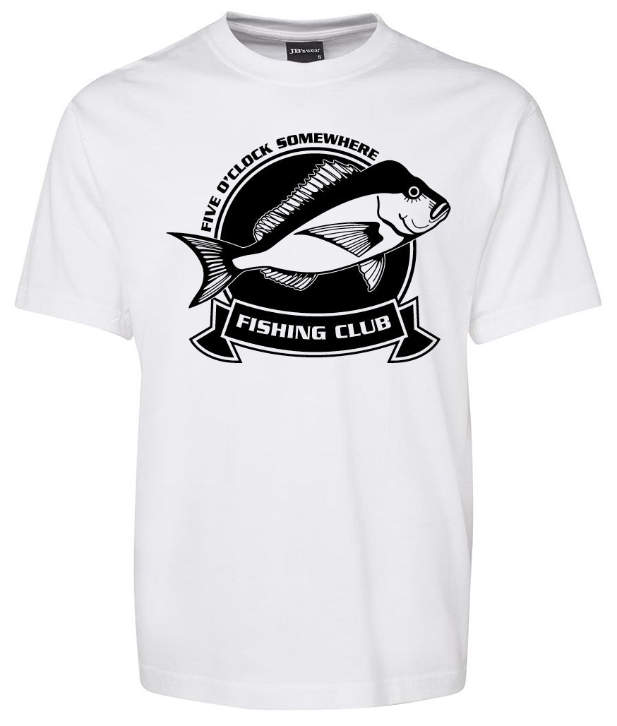 The Fishing Club Shirt by Corsa Clothing is a white tee with a black fish graphic, circular emblem, “FIVE O’CLOCK SOMEWHERE” above, and “FISHING CLUB” in a ribbon banner below.