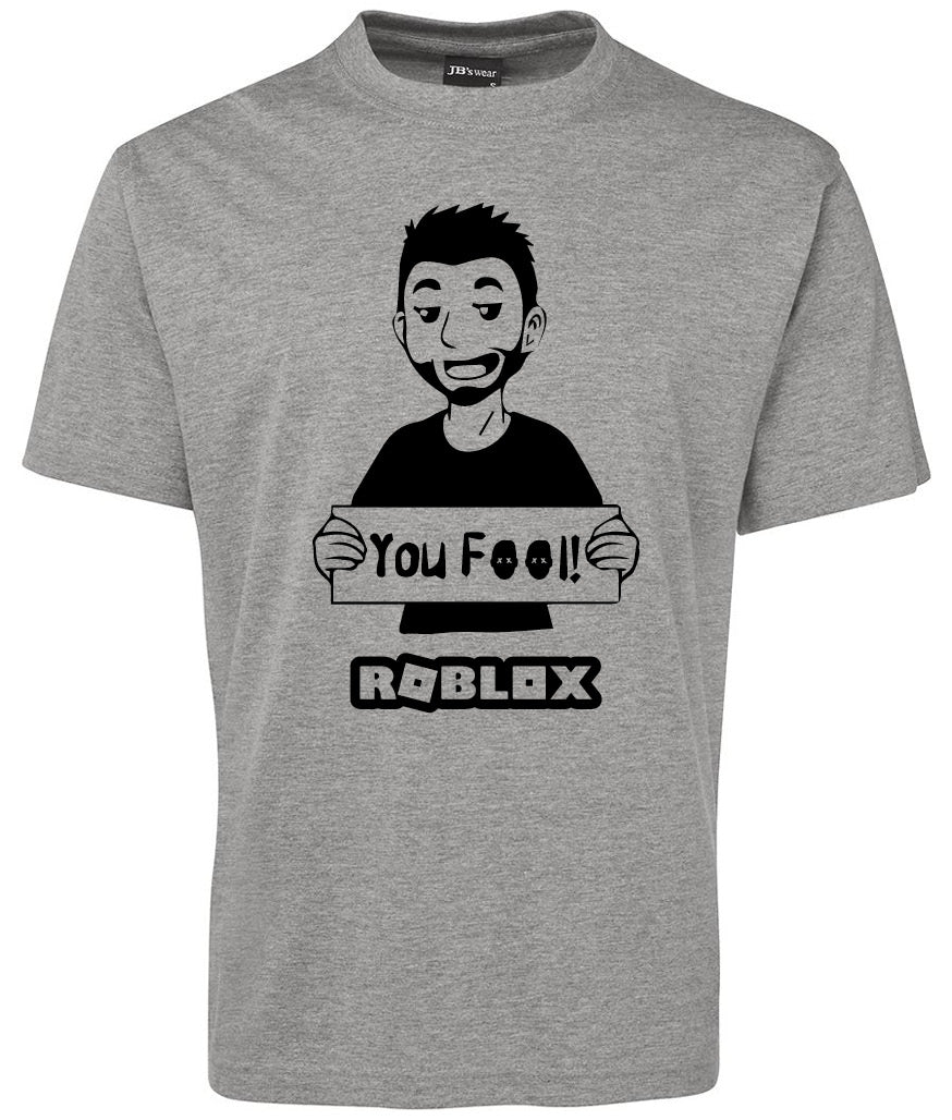 The You Fool Roblox Shirt by Corsa Clothing is a gray tee with a cartoon character holding a “You Fool!!” sign above bold black “ROBLOX” text.