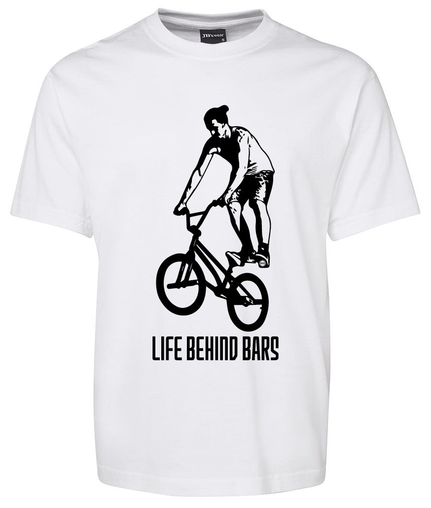 The Corsa Clothing Life Behind Bars BMX shirt is a white tee with a black graphic of a BMX rider and the phrase "LIFE BEHIND BARS" printed below.