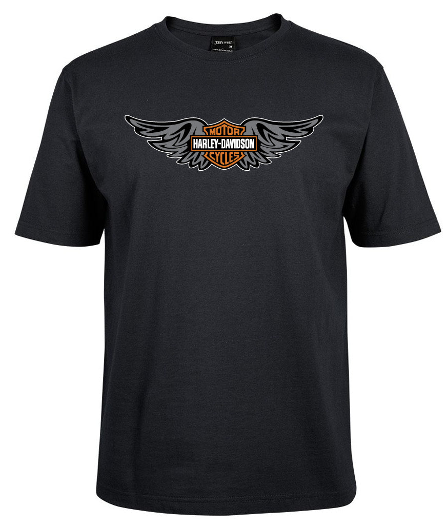 The Corsa Clothing Harley Wings Logo Shirt is a black tee with a Harley-Davidson logo in orange, black, and white, flanked by stylized wings on the chest.