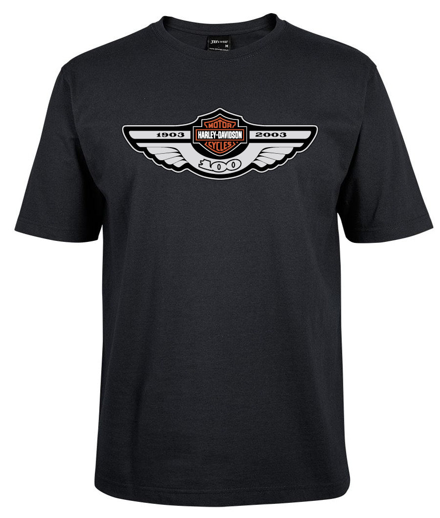 The Harley Wings 100 Years Shirt by Corsa Clothing is a black tee celebrating Harley-Davidson's centennial with winged logo and the years 1903–2003.