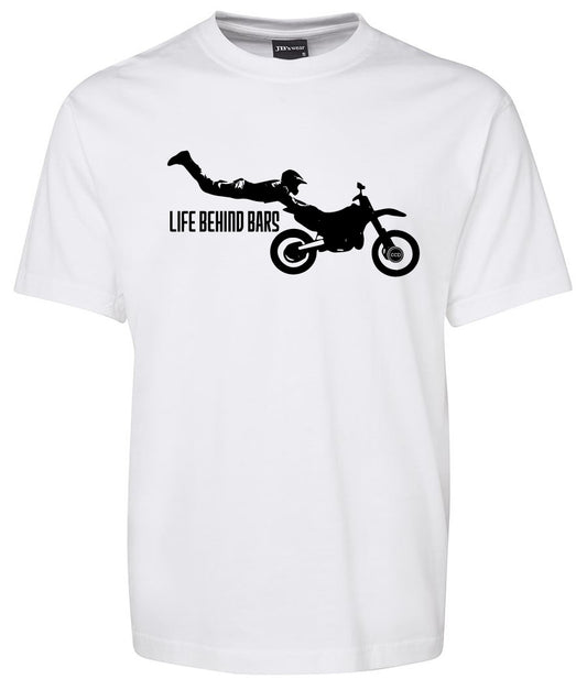 The Life Behind Bar Shirt by Corsa Clothing is a white tee with a black motocross rider silhouette performing a stunt above "LIFE BEHIND BARS" and a motorcycle graphic.
