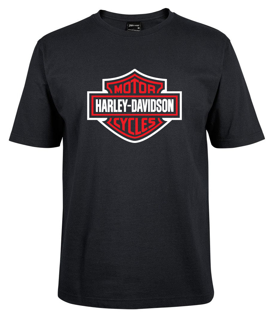 The Corsa Clothing Harley-Davidson Bar & Shield Shirt features the iconic logo in red with a white border on a black t-shirt, prominently displayed on the chest.