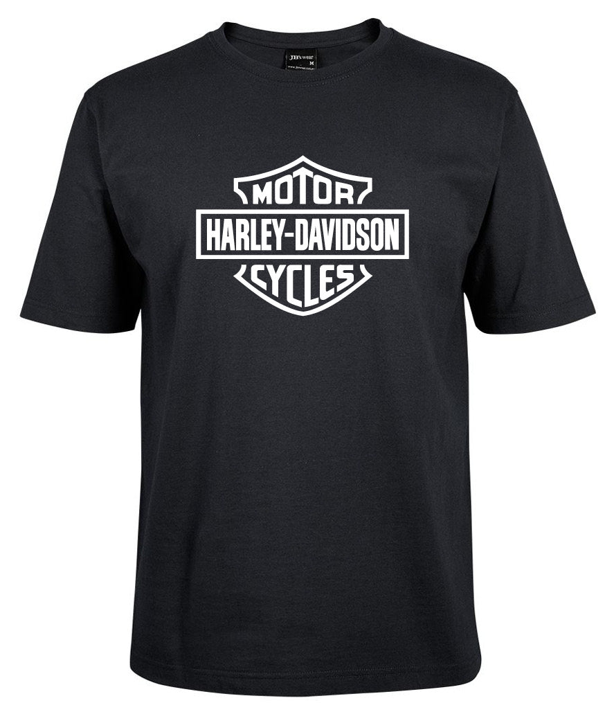The Harley-Davidson Bar & Shield Shirt White by Corsa Clothing features the iconic Harley-Davidson logo with "Motor" above and "Cycles" below the text in a shield design on the front.