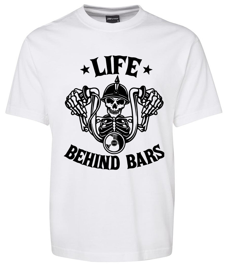 The Corsa Clothing Life Behind Bars Skeleton Shirt in white features a black graphic of a skeleton gripping motorcycle handlebars, with “Life Behind Bars” in bold text above and below the design.