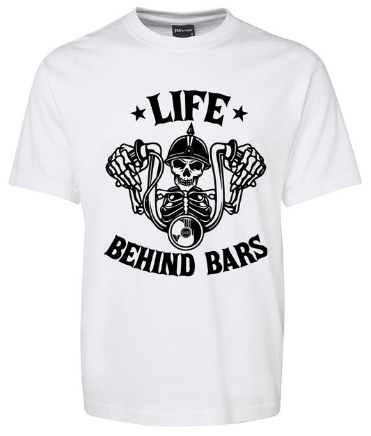 The Corsa Clothing Life Behind Bars Skeleton Shirt in white features a black graphic of a skeleton gripping motorcycle handlebars, with “Life Behind Bars” in bold text above and below the design.