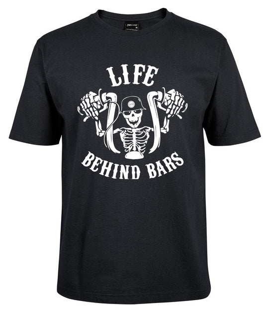 The Corsa Clothing Life behind bars Skeleton shirt in black features a white graphic of a helmeted skeleton gripping motorcycle handlebars, with “LIFE BEHIND BARS” printed above and below.