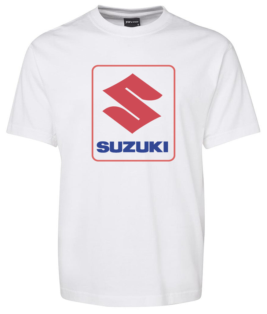 The Corsa Clothing Suzuki Shirt is a white tee featuring a large red Suzuki logo above blue "SUZUKI" lettering, centered on the chest.