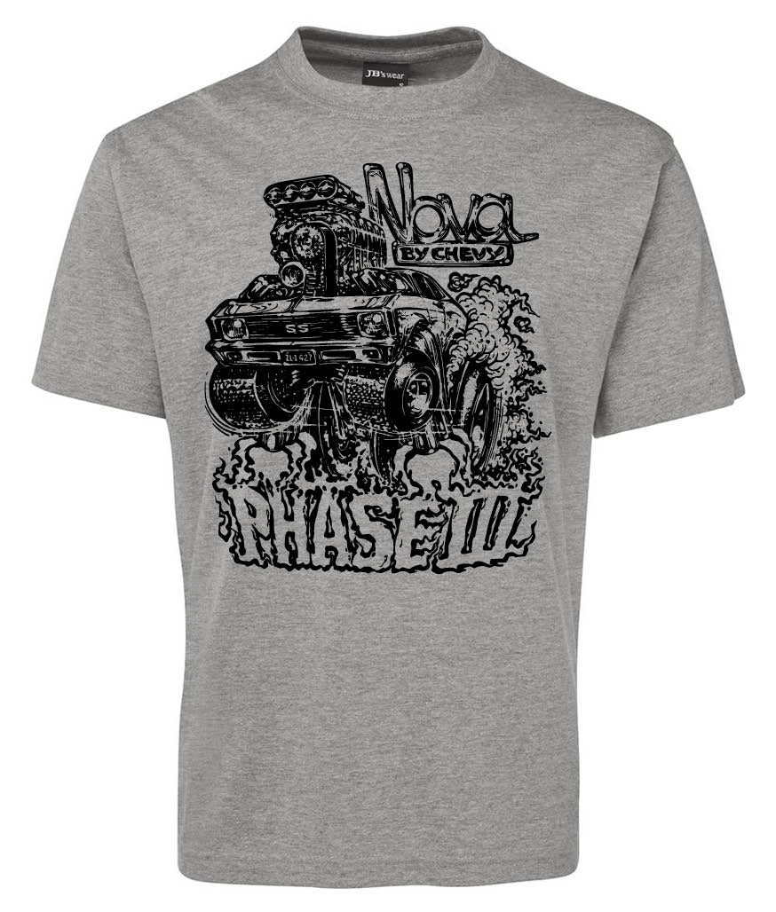 Corsa Clothing’s Phase III Shirt is a gray tee with a bold black graphic of a classic Chevy Nova, exaggerated rear tires, smoke, and the phrases “Nova by Chevy” and “PHASE III” in stylized fonts.