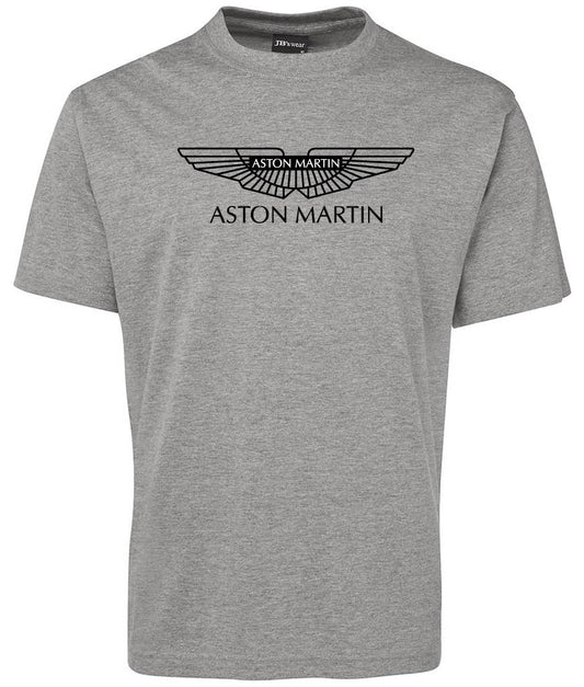 The Aston Martin Shirt by Corsa Clothing is a plain grey tee featuring the Aston Martin logo and "ASTON MARTIN" printed in black on the chest.