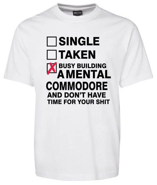 The COMMODORE Checkbox Shirt by Corsa Clothing is a white tee featuring checkboxes for Single, Taken, and a bold checked box reading "Busy building a mental Commodore and don’t have time for your shit" in black text.
