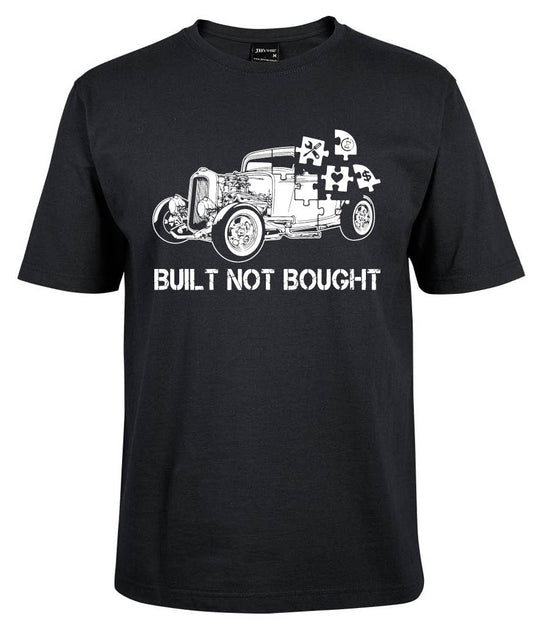 The Built Not Bought Shirt by Corsa Clothing is a black tee with a white graphic of a vintage car made of puzzle pieces and "BUILT NOT BOUGHT" in distressed capital letters.