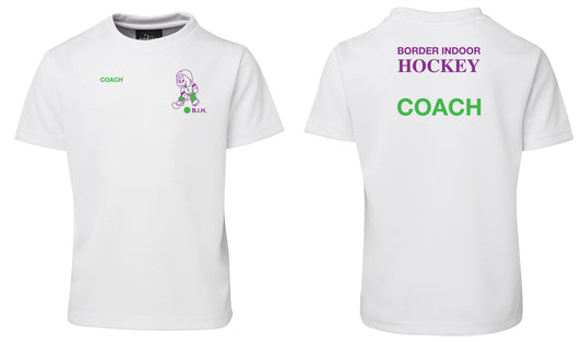 The Corsa Clothing border indood hokey shirt is white, featuring a small green COACH and purple hockey cartoon with B.I.H. on the front, plus BORDER INDOOR HOCKEY in purple and large green COACH text on the back.