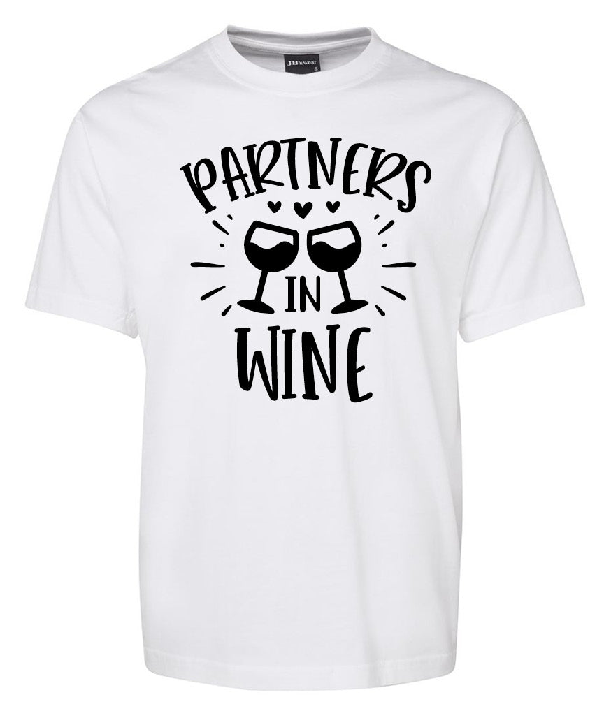 The Partners in Wine Shirt by Corsa Clothing features bold black “Partners in Wine” text and two illustrated wine glasses clinking with small hearts above them.