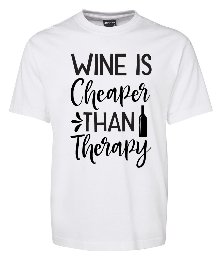 The Wine is cheeper then Therapy Shirt by Corsa Clothing features a white tee with bold black text and a wine bottle icon replacing the "i" in "therapy.