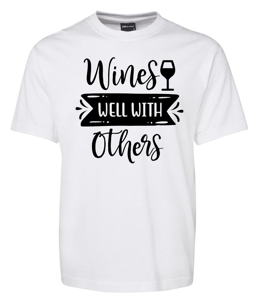 The Wine Well With Others Shirt by Corsa Clothing is a white tee featuring "Wines Well With Others" printed in black and a wine glass graphic above "Well.