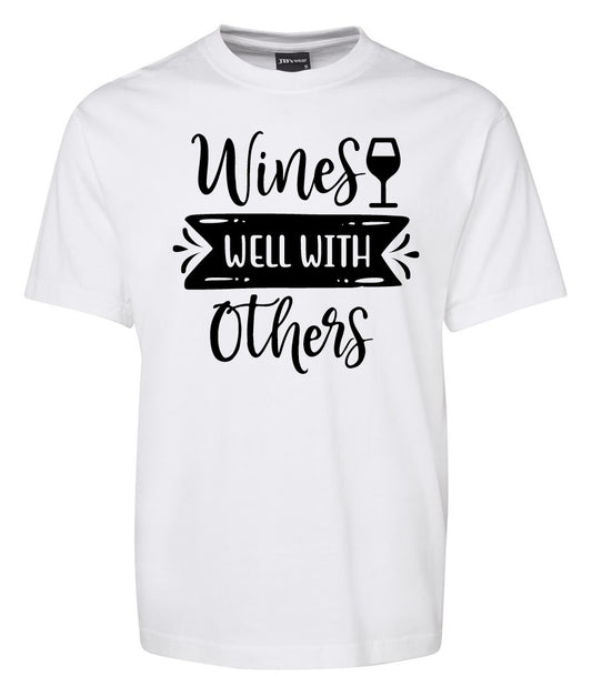 The Wine Well With Others Shirt by Corsa Clothing is a white tee featuring "Wines Well With Others" printed in black and a wine glass graphic above "Well.