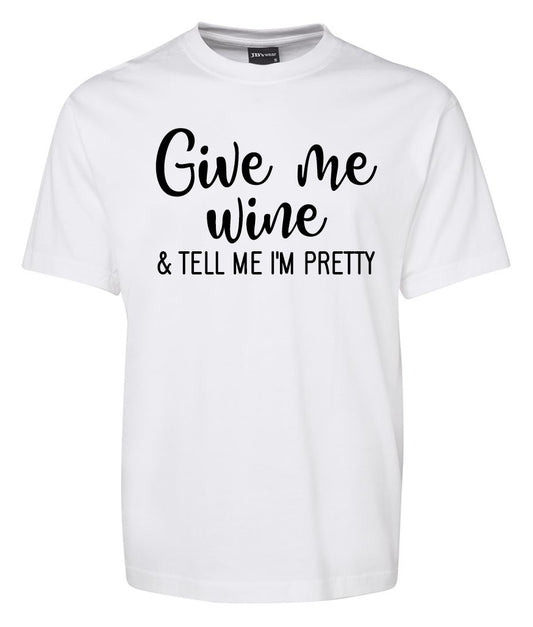The Corsa Clothing "Give me Wine & tell me im pretty" white t-shirt features black text and is shown on a plain background.