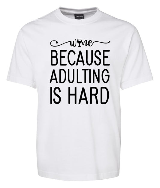 The Corsa Clothing Wine Because Adulting is Hard Shirt is a white tee with "Wine because adulting is hard" printed in large black letters on the front.
