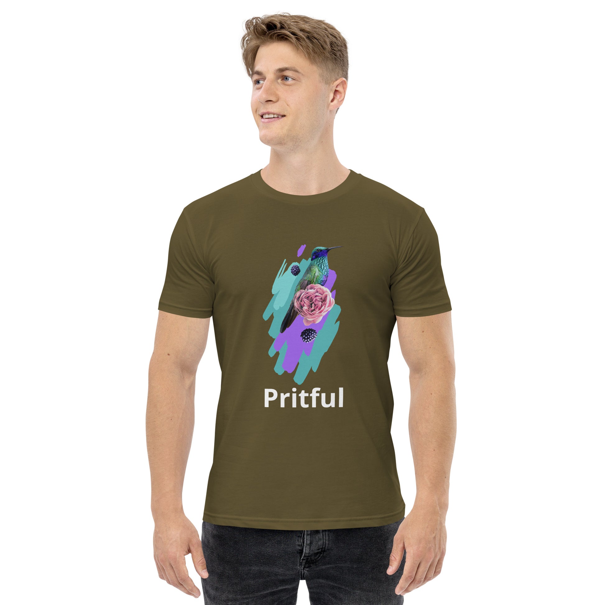 A smiling man wears an olive green Corsa Clothing men's staple tee featuring a colorful hummingbird, butterfly, and pink rose. "Pritful" appears in white below the design. This shirt is popular in Australia and New Zealand.