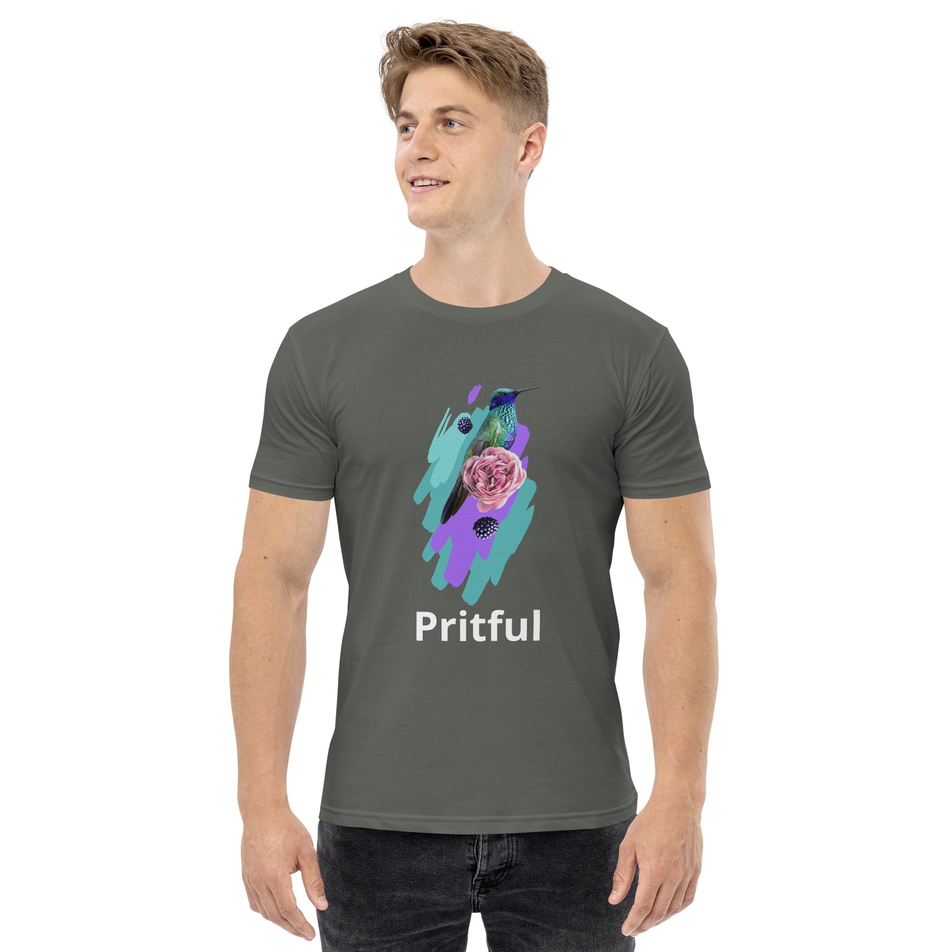 A young man wears the Corsa Clothing Men's staple tee—a gray cotton shirt featuring a colorful hummingbird, pink flower, purple brushstrokes, and "Pritful" below the artwork. He smiles and looks to the side. Popular in Australia and New Zealand.