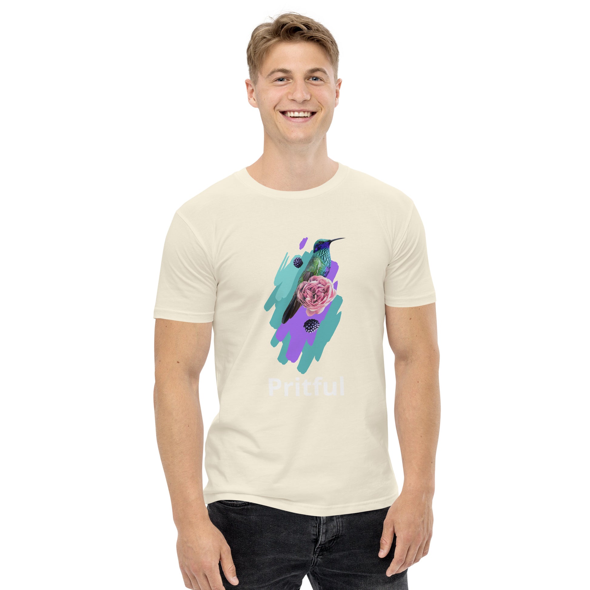 A smiling person wears Corsa Clothing’s Men's staple tee—a light cotton shirt with a vibrant hummingbird, flowers, and paint strokes graphic, "Pritful" below the design. Ideal for fans of Australia and New Zealand style.