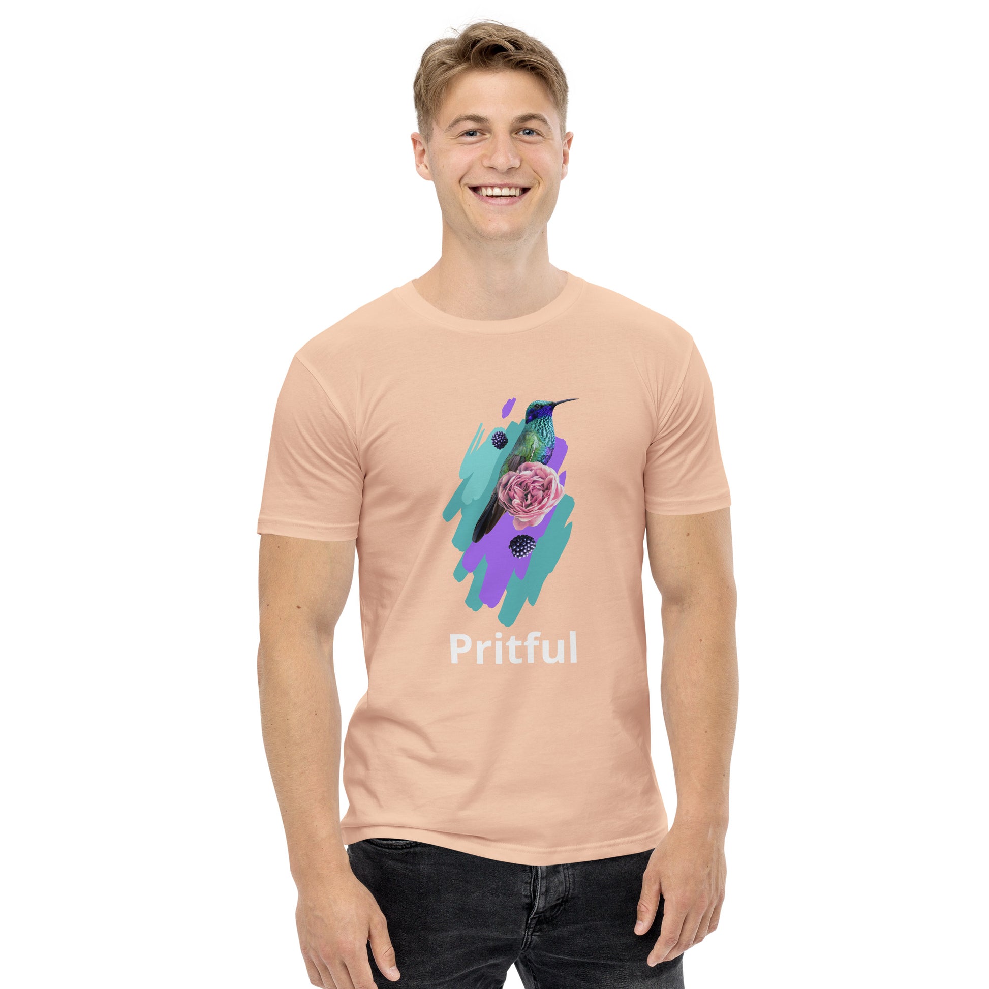 A smiling man wears the Corsa Clothing Men's staple tee in light pink, made from soft cotton, with a colorful bird, flower, and leaves graphic and "Pritful" text. He stands against a white background—ideal for Australia and New Zealand style.