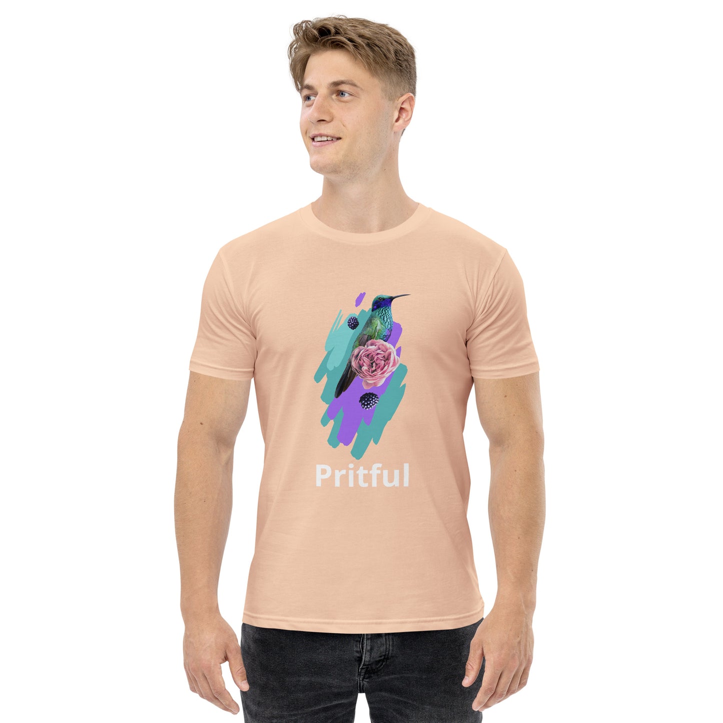 A smiling man wears Corsa Clothing’s men’s staple tee, a light peach cotton shirt with a colorful hummingbird and pink flower graphic, "Pritful" text below, perfect for Australia and New Zealand style lovers.