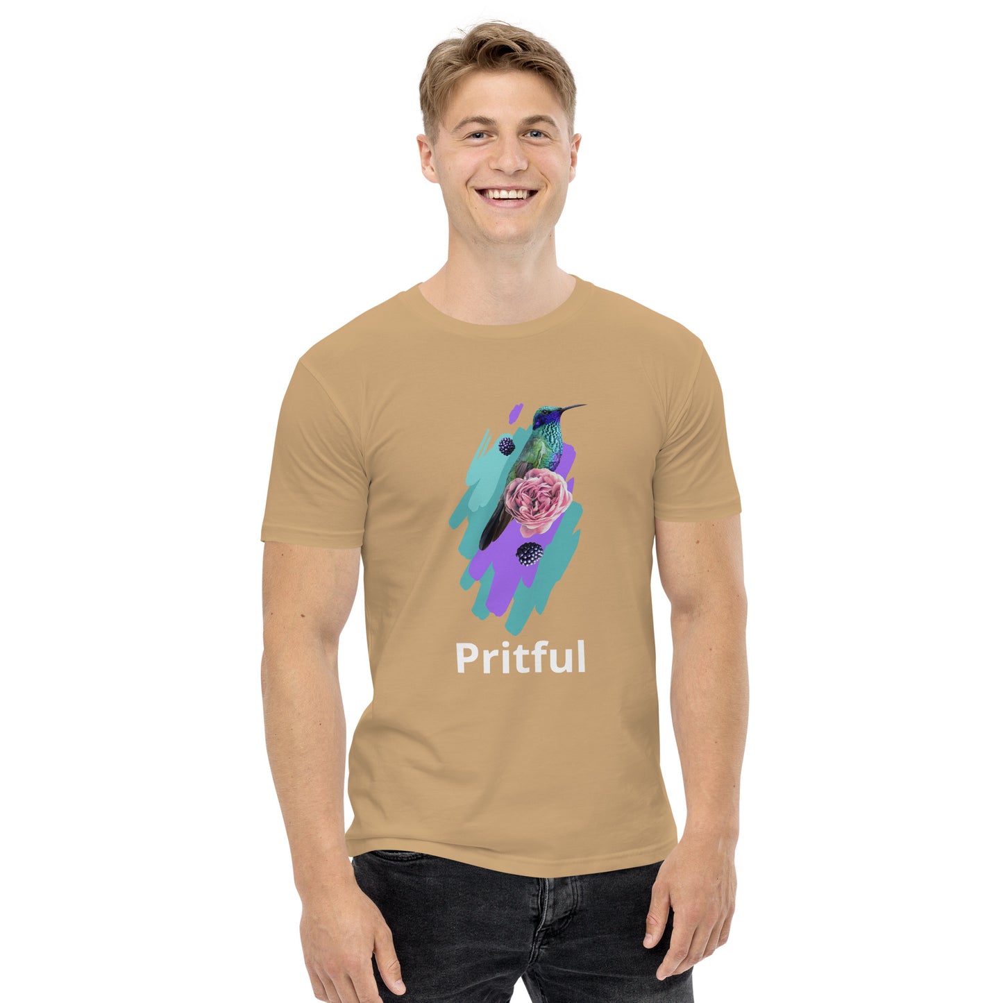 A smiling man wears the Corsa Clothing Men's staple tee, a tan cotton t-shirt with a vibrant hummingbird, purple rose, teal and purple brushstrokes, and "Pritful" text—perfect for Australia and New Zealand.