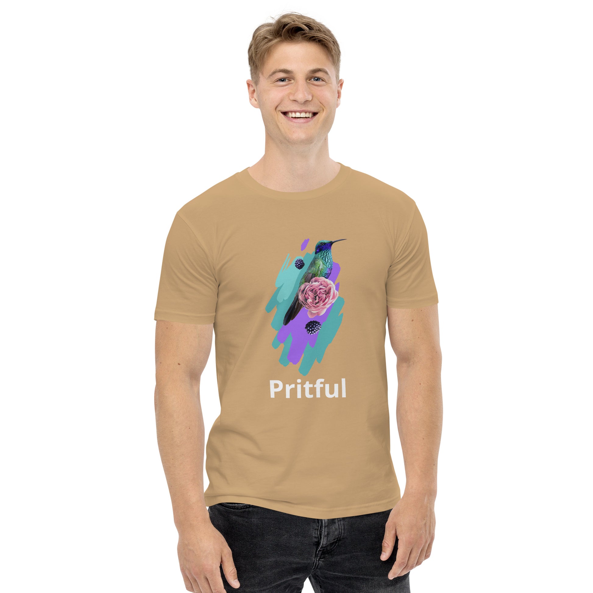 A smiling man wears the Corsa Clothing Men's staple tee, a tan cotton t-shirt with a vibrant hummingbird, purple rose, teal and purple brushstrokes, and "Pritful" text—perfect for Australia and New Zealand.