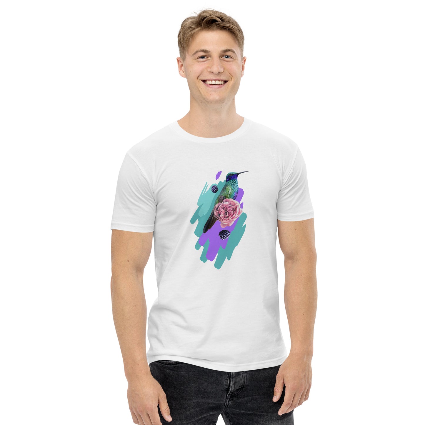 Smiling man wears the Corsa Clothing Men's staple tee—crafted from soft cotton and featuring a vibrant hummingbird, floral, and abstract teal-purple design inspired by Australia and New Zealand.