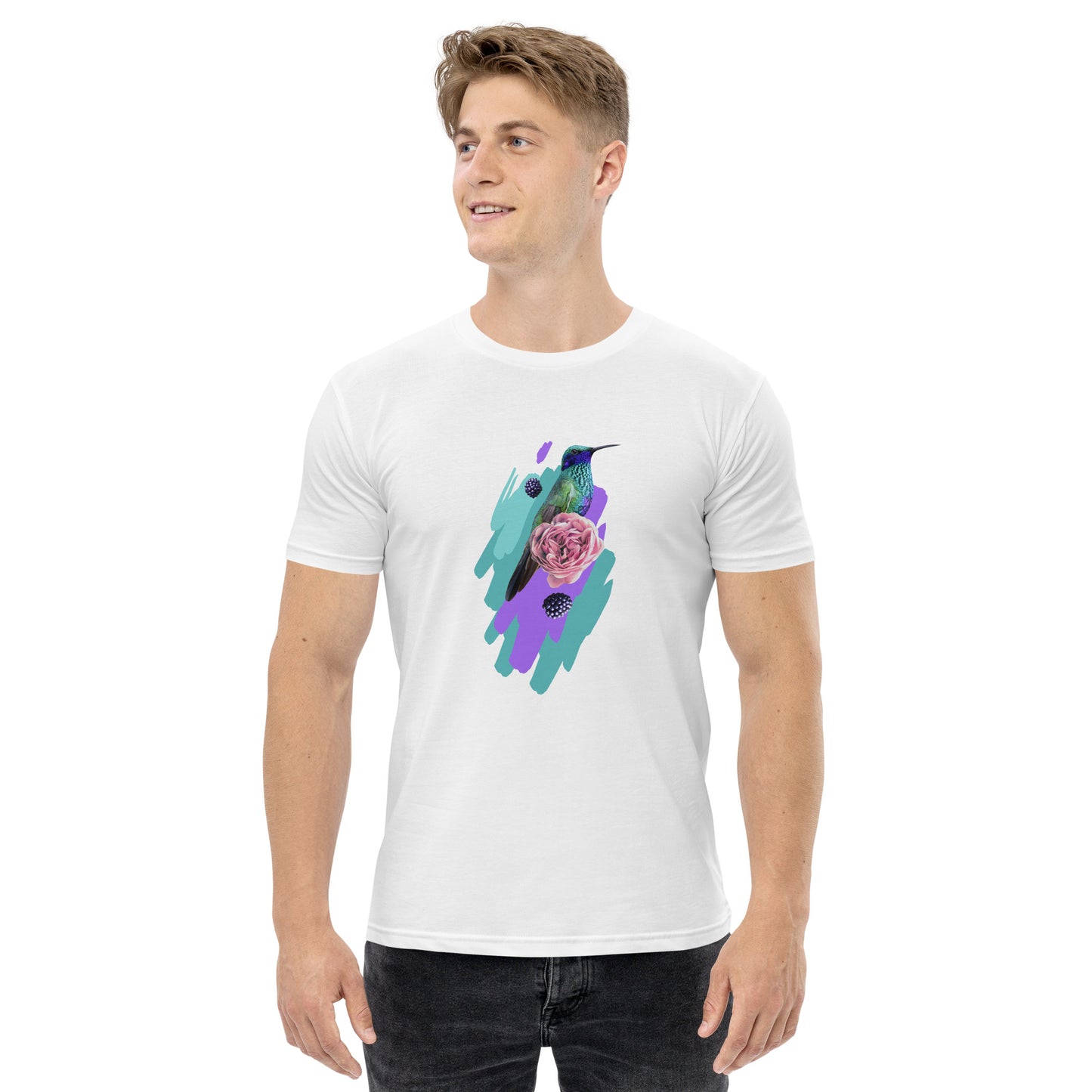 A man in the Corsa Clothing Men's staple tee—a white cotton t-shirt with a hummingbird, pink rose, and teal brush strokes—smiles slightly to the side, showcasing a style ideal for Australia and New Zealand.